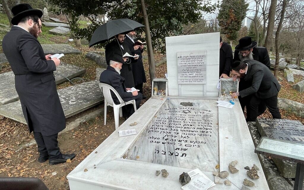 Haredi Orthodox pilgrims pray at the grave of Rabbi Naphtali Tzvi Katz, a 17th-century Kabbalist, in the Ortakoy neighborhood of Istanbul, January 17, 2023. (David I. Klein/JTA)