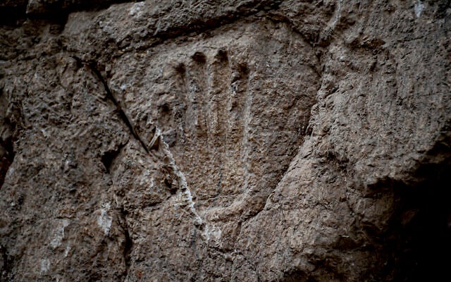 A carved hand imprint discovered in an ancient moat wall around the Old City of Jerusalem. (Yoli Schwartz/Israel Antiquities Authority)