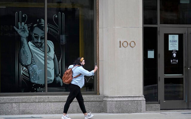 A woman walks past a window featuring a likeness of chef and social media star Salt Bae outside the Nusr-Et Boston restaurant, in Boston, September 29, 2020. (Steven Senne/AP) A woman walks past a window featuring a likeness of chef and social media star Salt Bae outside the Nusr-Et Boston restaurant, in Boston, September 29, 2020. (Steven Senne/AP)