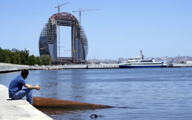 A man rests on the bank of the Caspian Sea in Baku, Azerbaijan, Monday, June 7, 2021. (AP/Darko Vojinovic)
