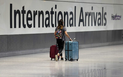 Illustrative: A passenger arrives from a flight at Terminal 5 of Heathrow Airport in London, August 2, 2021. (Matt Dunham/AP)