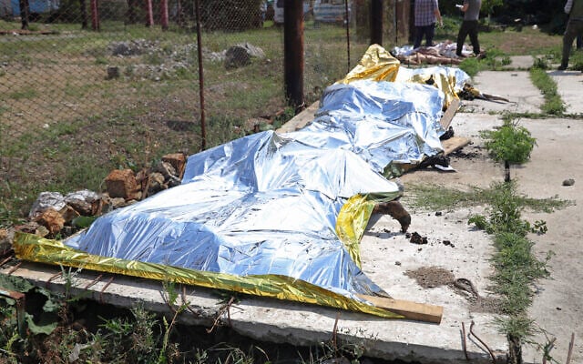 Investigators examine bodies of Ukrainian military prisoners at a prison in Olenivka, in an area controlled by Russian-backed separatist forces, eastern Ukraine, on July 29, 2022. (AP Photo) Investigators examine bodies of Ukrainian military prisoners at a prison in Olenivka, in an area controlled by Russian-backed separatist forces, eastern Ukraine, on July 29, 2022. (AP Photo)
