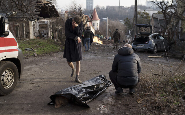 A man reacts next to the body of his wife, killed during a Russian attack in Kyiv, Ukraine, Dec. 31, 2022. (AP Photo/Roman Hrytsyna) A man reacts next to the body of his wife, killed during a Russian attack in Kyiv, Ukraine, Dec. 31, 2022. (AP Photo/Roman Hrytsyna)