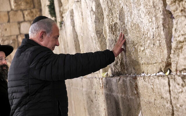 Prime Minister Benjamin Netanyahu prays as he visits the Western Wall in the Old City of Jerusalem, January 1, 2023. (Gil Cohen-Magen/Pool via AP) Prime Minister Benjamin Netanyahu prays as he visits the Western Wall in the Old City of Jerusalem, January 1, 2023. (Gil Cohen-Magen/Pool via AP)