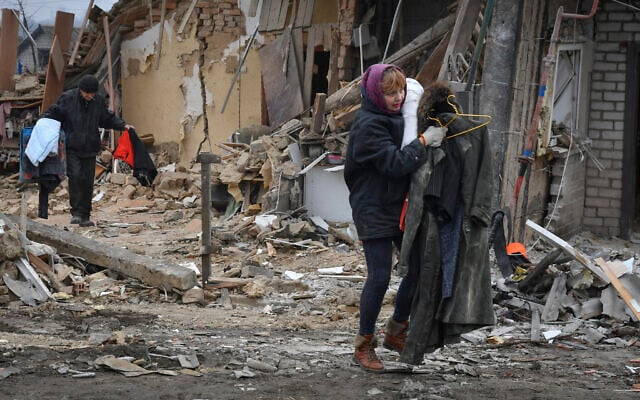 Local residents carry their belongings as they leave their home ruined in the Saturday Russian rocket attack in Zaporizhzhya, Ukraine, January 1, 2023. (AP Photo/Andriy Andriyenko) Local residents carry their belongings as they leave their home ruined in the Saturday Russian rocket attack in Zaporizhzhya, Ukraine, January 1, 2023. (AP Photo/Andriy Andriyenko)