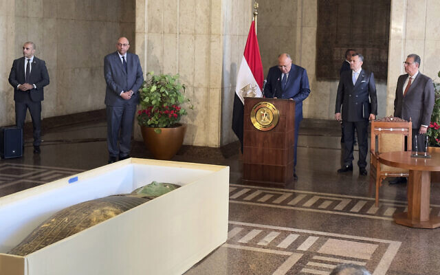 Foreign Minister Sameh Shoukry, center, standing in front of an ancient wooden sarcophagus, speaks during a handover ceremony at the foreign ministry in Cairo, Egypt, January 2, 2023. (AP Photo/Mohamed Salah) Foreign Minister Sameh Shoukry, center, standing in front of an ancient wooden sarcophagus, speaks during a handover ceremony at the foreign ministry in Cairo, Egypt, January 2, 2023. (AP Photo/Mohamed Salah)