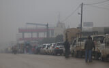 People queue up for gasoline in Idlib province, Syria, Sunday Dec. 15, 2022 (AP Photo/Ghaith Alsayed)