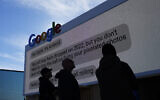 Workers help set up the Google booth at the Las Vegas Convention Center before the start of the CES tech show, January 2, 2023, in Las Vegas. (AP/John Locher)