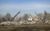 Workers clean rubbles after Ukrainian rocket strike in Makiivka, in Russian-controlled Donetsk region, eastern Ukraine, January 3, 2023. (AP Photo)