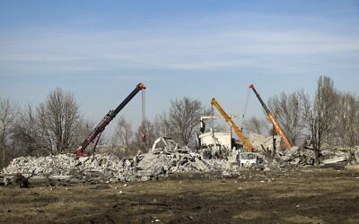 Workers clean rubbles after Ukrainian rocket strike in Makiivka, in Russian-controlled Donetsk region, eastern Ukraine, January 3, 2023. (AP Photo)