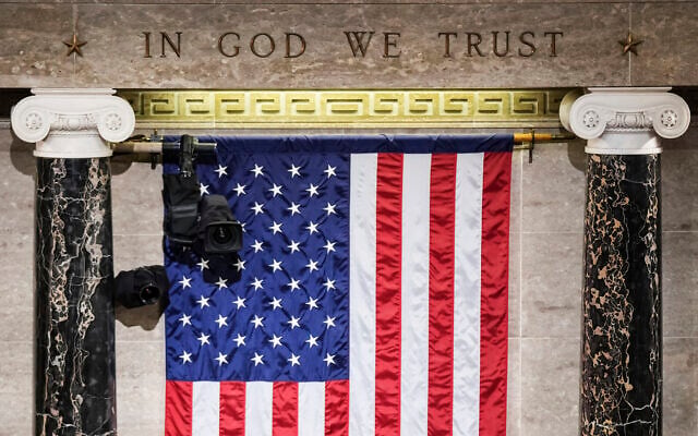 'In God We Trust' is engraved in stone above a U. flag in the House of Representatives chamber at the Capitol in Washington on Tuesday, March 1, 2022.(Sarahbeth Maney/The New York Times via AP, Pool) 'In God We Trust' is engraved in stone above a U. flag in the House of Representatives chamber at the Capitol in Washington on Tuesday, March 1, 2022.(Sarahbeth Maney/The New York Times via AP, Pool)