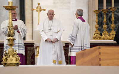 Pope Francis stands by the coffin of late Pope Emeritus Benedict XVI St. Peter's Square during a funeral mass at the Vatican, January 5, 2023. (Andrew Medichini/AP)