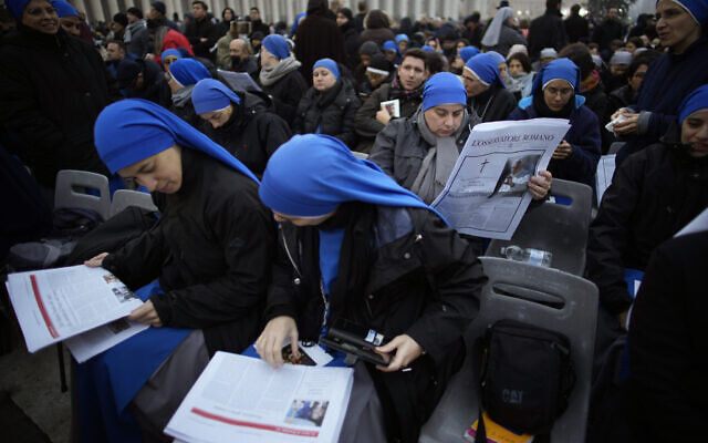 People occupy their positions at the St. Peter's Square at the Vatican ahead of the funeral mass for late Pope Emeritus Benedict XVI, Thursday, Jan. 5, 2023. Benedict died at 95 on Dec. 31 in the monastery on the Vatican grounds where he had spent nearly all of his decade in retirement, his days mainly devoted to prayer and reflection. (AP Photo/Domenico Stinellis)
