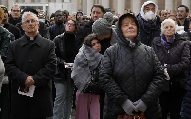 Faithful attend the funeral mass for late Pope Emeritus Benedict XVI in St. Peter's Square at the Vatican, Thursday, Jan. 5, 2023. Benedict died at 95 on Dec. 31 in the monastery on the Vatican grounds where he had spent nearly all of his decade in retirement. (AP Photo/Gregorio Borgia)