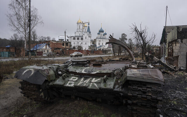 A destroyed Russian tank stands across the road of a church in the town of Sviatohirsk, Ukraine, Friday, January 6, 2023. (AP Photo/Evgeniy Maloletka) A destroyed Russian tank stands across the road of a church in the town of Sviatohirsk, Ukraine, Friday, January 6, 2023. (AP Photo/Evgeniy Maloletka)