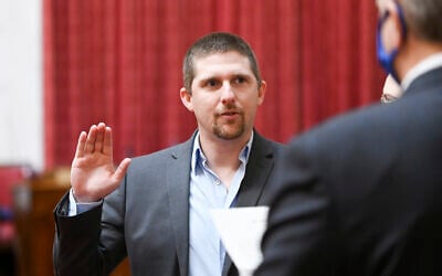 In this image provided by the West Virginia Legislative Photography, Derrick Evans is shown during his swearing-in ceremony to the West Virginia House of Delegates on December 1, 2020, in Charleston, West Virginia. (Will Price, West Virginia Legislative Photography via AP)