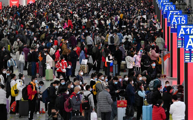 In this photo released by Xinhua News Agency, people wearing face masks with their luggage prepare to catch their trains at the North Railway Station in Shenzhen in south China's Guangdong province, Saturday, Jan. 7, 2023. (Liang Xu/Xinhua via AP) In this photo released by Xinhua News Agency, people wearing face masks with their luggage prepare to catch their trains at the North Railway Station in Shenzhen in south China's Guangdong province, Saturday, Jan. 7, 2023. (Liang Xu/Xinhua via AP)
