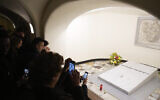 Faithful visit the tomb of late Pope Emeritus Benedict XVI inside the grottos of St. Peter's Basilica, at the Vatican, January 8, 2023. (Gregorio Borgia/AP)