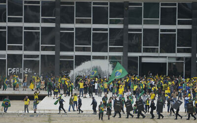 Protesters, supporters of Brazil's former President Jair Bolsonaro, storm the Supreme Court building in Brasilia, Brazil, Sunday, January 8, 2023. (AP/Eraldo Peres)