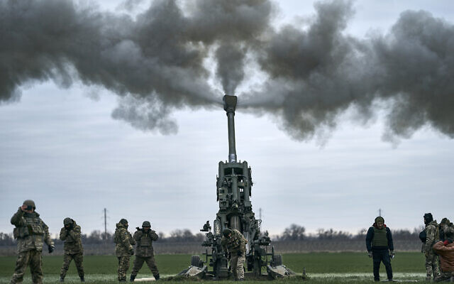 Ukrainian soldiers fire at Russian positions from a US-supplied M777 howitzer in Kherson region, Ukraine, January 9, 2023. (AP Photo/Libkos)