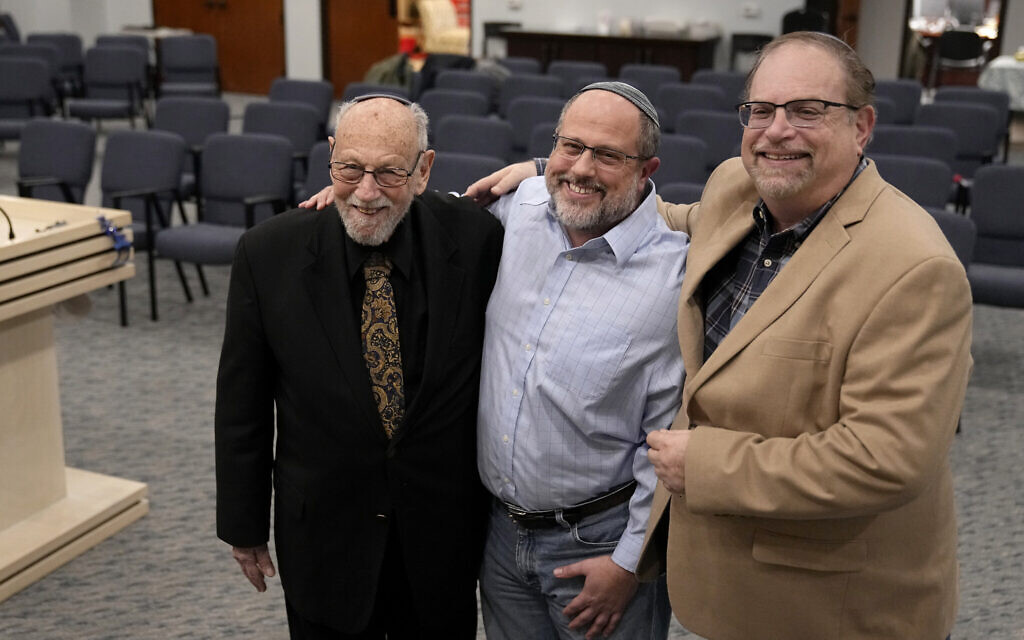 In this December 22, 2022, photo, Lawrence Schwartz, left, Shane Woodward, center, and Jeff Cohen, right, smile as they pose for a photo inside Congregation Beth Israel in Colleyville, Texas. (AP Photo/Tony Gutierrez) In this December 22, 2022, photo, Lawrence Schwartz, left, Shane Woodward, center, and Jeff Cohen, right, smile as they pose for a photo inside Congregation Beth Israel in Colleyville, Texas. (AP Photo/Tony Gutierrez)