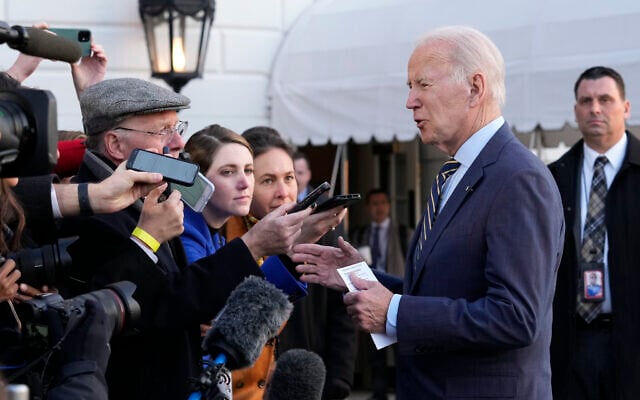 US President Joe Biden talks with reporters before he and first lady Jill Biden board Marine One on the South Lawn of the White House in Washington, Wednesday, Jan. 11, 2023.  (AP Photo/Susan Walsh)