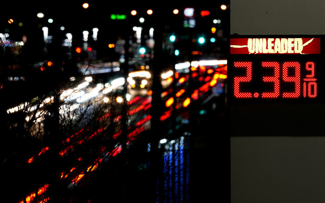 File - Cars pass a gas station sign displaying the price of regular unleaded gasoline Tuesday, Dec. 13, 2022, in Benton, Mo. On Thursday, the Labor Department reports on U.S. consumer prices for December. (AP Photo/Charlie Riedel, File)