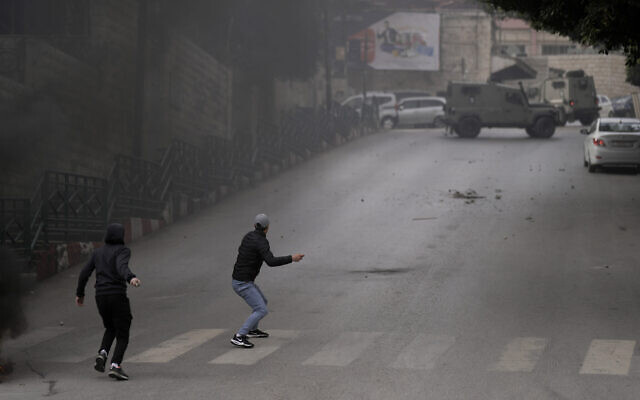 Palestinians clash with Israeli security forces during an army operation in the West Bank city of Nablus, January 12, 2023. (AP Photo/Majdi Mohammed) Palestinians clash with Israeli security forces during an army operation in the West Bank city of Nablus, January 12, 2023. (AP Photo/Majdi Mohammed)