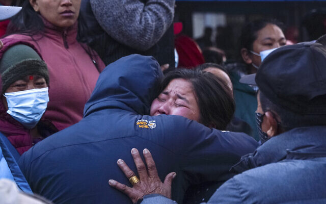 A woman cries as the body of a relative, victim of a plane crash, is brought to a hospital in Pokhara, Nepal, January 15, 2023. (AP Photo/Yunish Gurung) A woman cries as the body of a relative, victim of a plane crash, is brought to a hospital in Pokhara, Nepal, January 15, 2023. (AP Photo/Yunish Gurung)