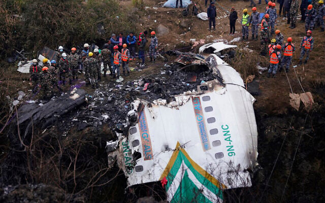 Rescuers scour the crash site in the wreckage of a passenger plane in Pokhara, Nepal, Monday, Jan.16, 2023..(AP Photo/Yunish Gurung) Rescuers scour the crash site in the wreckage of a passenger plane in Pokhara, Nepal, Monday, Jan.16, 2023..(AP Photo/Yunish Gurung)
