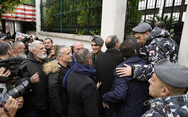 Relatives of the Aug. 4, 2020, Beirut port explosion and their lawyers enter a Beirut police barracks for an interrogation, in Beirut, Lebanon, Jan. 16, 2023. (AP Photo/Bilal Hussein)