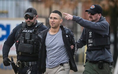 Solomon Pena, center, a Republican candidate for New Mexico House District 14, is taken into custody by Albuquerque Police officers, Monday, Jan. 16, 2023, in southwest Albuquerque, New Mexico (Roberto E. Rosales/The Albuquerque Journal via AP)