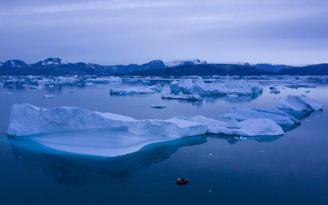 File: A boat navigates at night next to large icebergs near the town of Kulusuk, in eastern Greenland on August 15, 2019. (AP/Felipe Dana) File: A boat navigates at night next to large icebergs near the town of Kulusuk, in eastern Greenland on August 15, 2019. (AP/Felipe Dana)