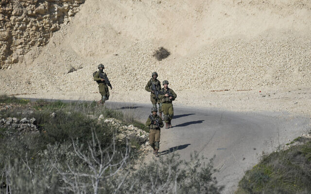 Soldiers patrol the scene after a Palestinian was shot and killed following an alleged attempted attack on an Israeli, next to Sde Efraim farm in the West Bank, Saturday, January 21, 2023. (AP Photo/Mahmoud Illean) Soldiers patrol the scene after a Palestinian was shot and killed following an alleged attempted attack on an Israeli, next to Sde Efraim farm in the West Bank, Saturday, January 21, 2023. (AP Photo/Mahmoud Illean)