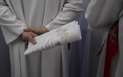 A member of Lutheran Christian clergy walks in a procession for the ordination of Sally Ibrahim Azar, a Palestinian Christian and Council member of the Lutheran World Federation, the first female pastor in the Holy Land, in the Old City of Jerusalem, January 22, 2023. (AP Photo/ Maya Alleruzzo)