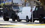 A van is surrounded by SWAT personnel in Torrance Calif., Sunday, Jan. 22, 2023. (AP Photo/Damian Dovarganes)