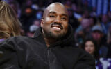 FILE - Kanye West, known as Ye, watches the first half of an NBA basketball game between the Washington Wizards and the Los Angeles Lakers in Los Angeles, on March 11, 2022(AP Photo/Ashley Landis, File)