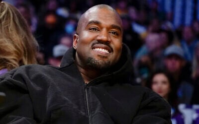 FILE - Kanye West, known as Ye, watches the first half of an NBA basketball game between the Washington Wizards and the Los Angeles Lakers in Los Angeles, on March 11, 2022(AP Photo/Ashley Landis, File)