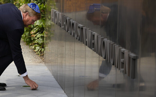 King Willem-Alexander puts a stone in an act of remembrance when unveiling a new monument in the heart of Amsterdam's historic Jewish Quarter on Sept. 19, 2021, honoring the 102,000 Dutch victims of the Holocaust. (AP Photo/Peter Dejong, File)