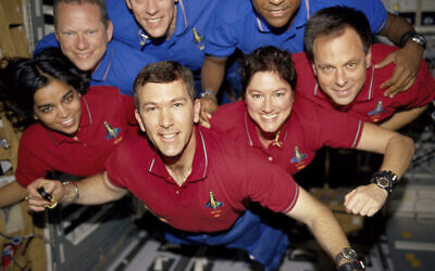 This undated photo released in June 2003 provided by NASA shows STS-107 crew members aboard the Space Shuttle Columbia. On Feb. 1, 2003, the seven crew members were lost as the Columbia fell apart over East Texas. From the left (bottom row), wearing red shirts to signify their shift's color, are mission specialist Kalpana Chawla, commander, Rick D. Husband, mission commander Laurel B. Clark and Ilan Ramon, and Israeli payload specialist. From the left (top row), wearing blue shirts, are mission specialist David M. Brown, pilot William C. McCool, pilot; and payload commander Michael P. Anderson. (NASA via AP)