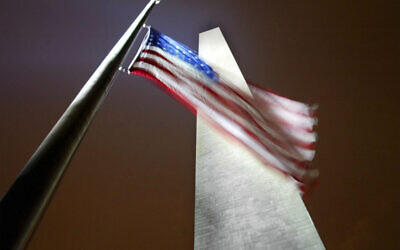 A US flag, along the base of the Washington Monument, flies at half-staff in memorial of those who died aboard space shuttle Columbia, in Washington, February 1, 2003. (Pablo Martinez Monsivais/AP)