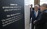 Antonio Guterres, United Nations Secretary General, center, and Dani Dayan, Chairman of Yad Vashem, far right, look at the Yad Vashem Book of Names of Holocaust Victims Exhibit, Thursday, Jan. 26, 2023, at United Nations headquarters. (AP Photo/John Minchillo)