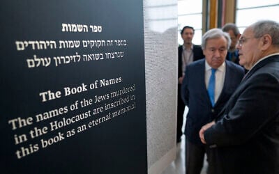Antonio Guterres, United Nations Secretary General, center, and Dani Dayan, Chairman of Yad Vashem, far right, look at the Yad Vashem Book of Names of Holocaust Victims Exhibit, Thursday, Jan. 26, 2023, at United Nations headquarters. (AP Photo/John Minchillo)