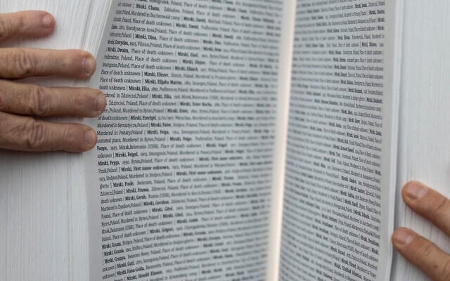 Gilad Erdan, Permanent Representative of Israel to the United Nations, Antonio Guterres, United Nations Secretary General, and Dani Dayan, Chairman of Yad Vashem, inspect the Yad Vashem Book of Names of Holocaust Victims Exhibit, Thursday, Jan. 26, 2023, at United Nations headquarters. (AP Photo/John Minchillo)