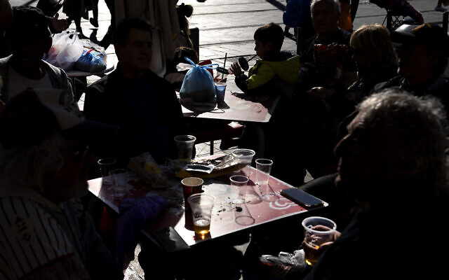 People drink in disposable plastic glass at Mahane Yehuda market in Jerusalem, January 20, 2023. (Oded Balilty/AP) People drink in disposable plastic glass at Mahane Yehuda market in Jerusalem, January 20, 2023. (Oded Balilty/AP)