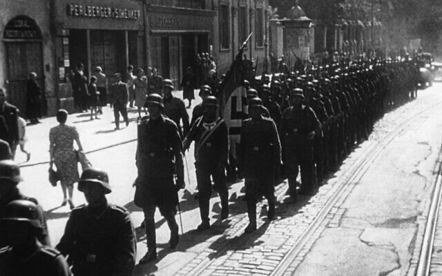 German troops carrying a Nazi flag enter the Polish town of Lodz, October 9, 1939. (AP Photo/Pool/Paramount News) German troops carrying a Nazi flag enter the Polish town of Lodz, October 9, 1939. (AP Photo/Pool/Paramount News)