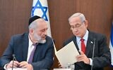 Prime Minister Benjamin Netanyahu (right) reads a letter to Shas chair Aryeh Deri, informing Deri that he must remove him from ministerial office, at the weekly cabinet meeting in Jerusalem, January 22, 2023. (Kobi Gideon/GPO)