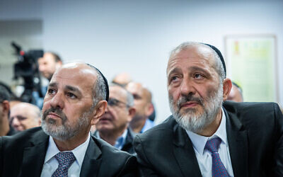 Shas' Ya'akov Margi (L) with party leader Aryeh Deri in Jerusalem on January 1, 2023 (Yonatan Sindel/Flash90)
