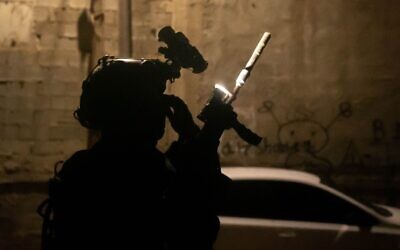 Illustrative: An IDF soldier is seen with night-vision equipment during a raid in the West Bank, early January 13, 2023. (Israel Defense Forces)