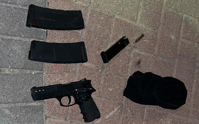 A gun and magazines found in a bag thrown from a car by Palestinians suspected of shooting at a military post near Bethlehem, January 21, 2023. (Israel Defense Forces) A gun and magazines found in a bag thrown from a car by Palestinians suspected of shooting at a military post near Bethlehem, January 21, 2023. (Israel Defense Forces)